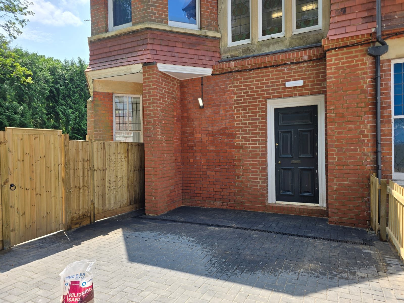 Block paved driveway with drainage channel laid at a front entrance