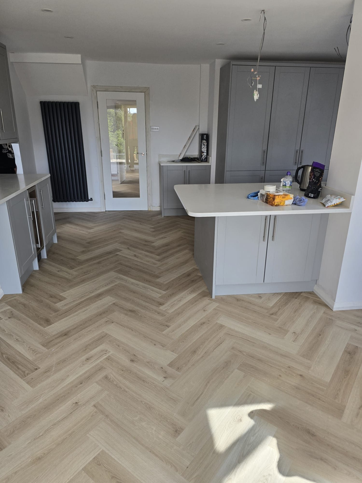 Grey kitchen and herringbone flooring after a full house refurbishment