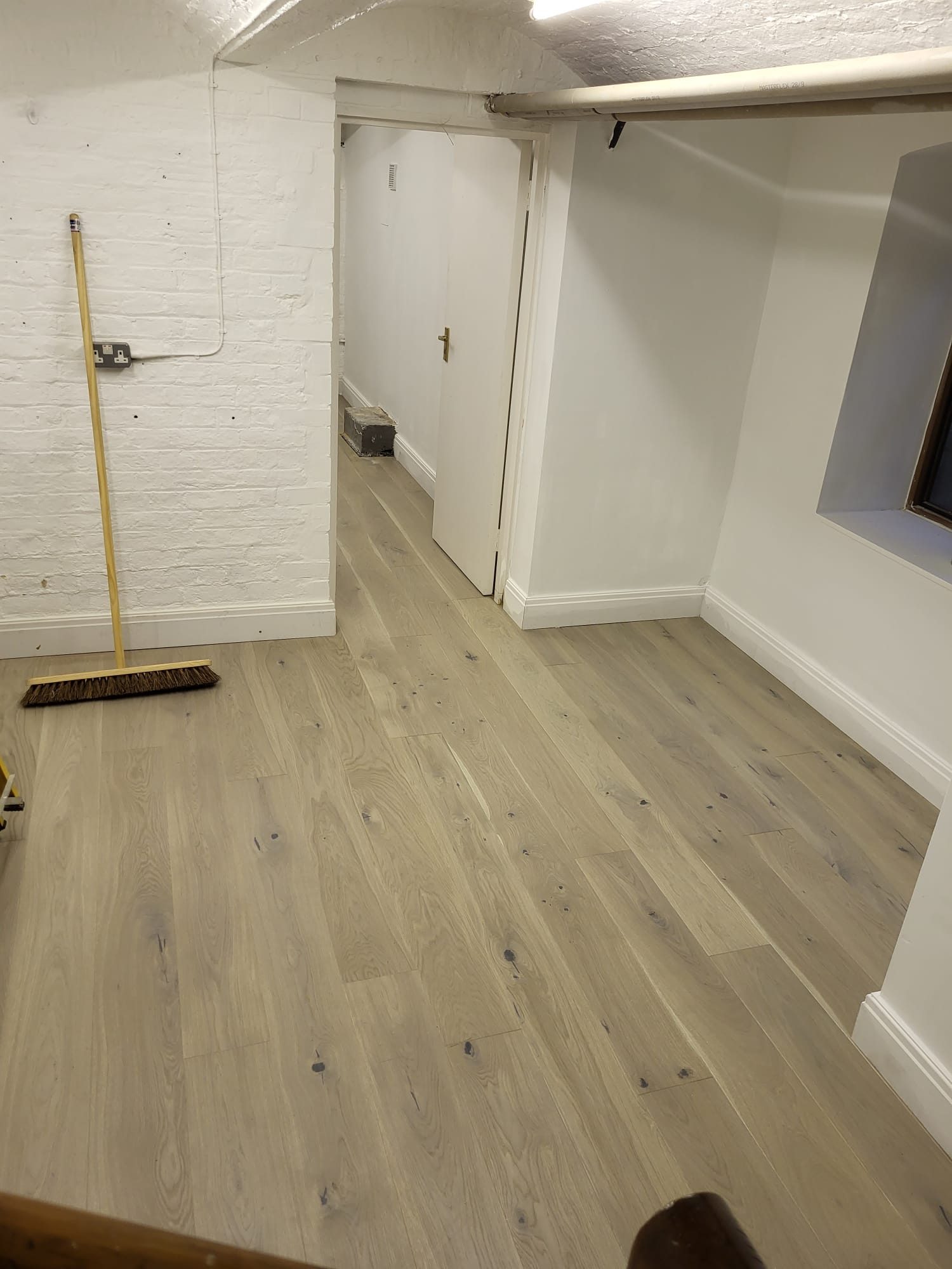 Engineered oak flooring fitted in a refurbished lower ground floor room