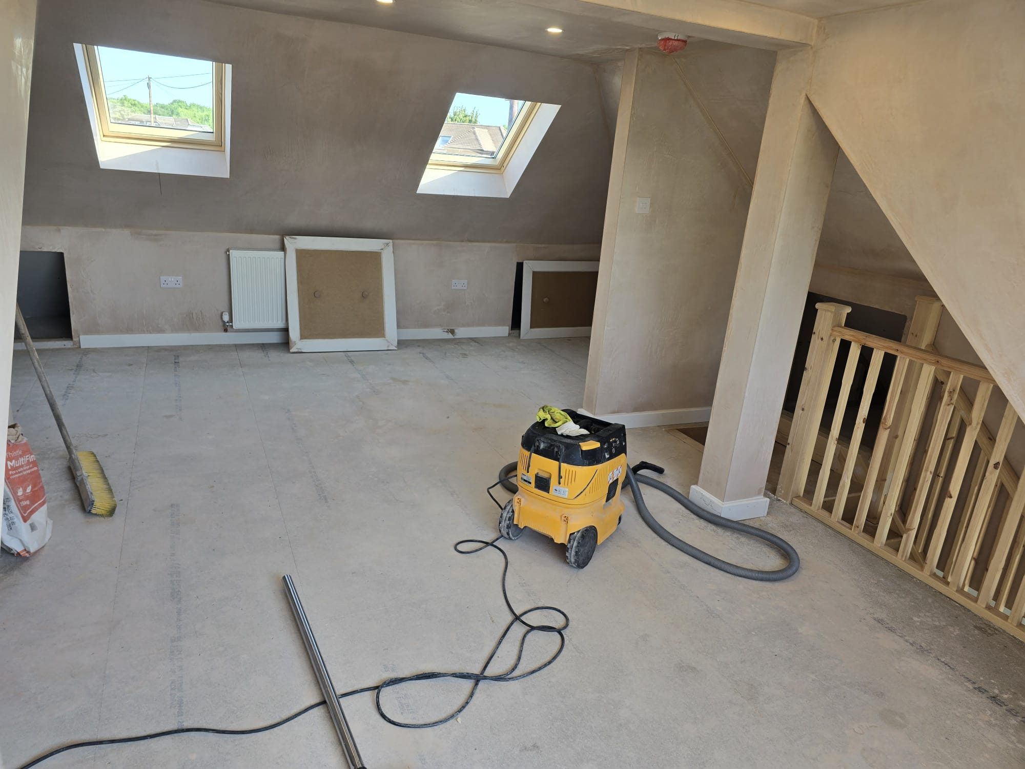 Loft conversion room with roof windows, plastered walls and new staircase