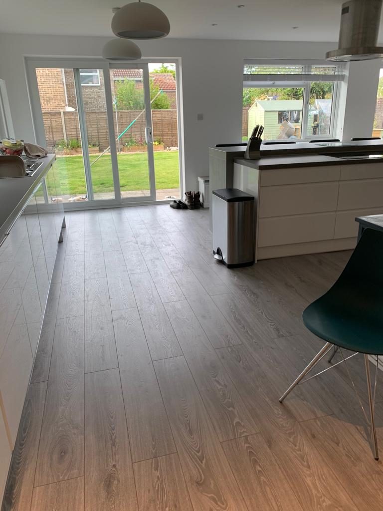 Refurbished kitchen with new flooring and patio doors onto the garden