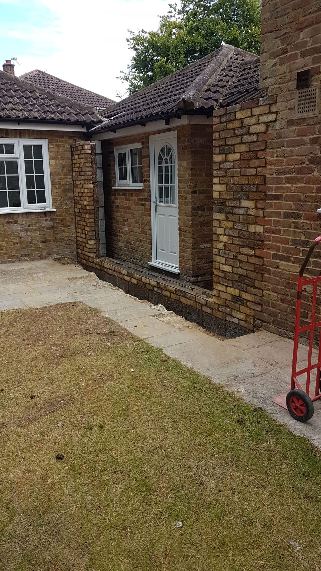 Brickwork and new doorway opening formed on a bungalow side extension