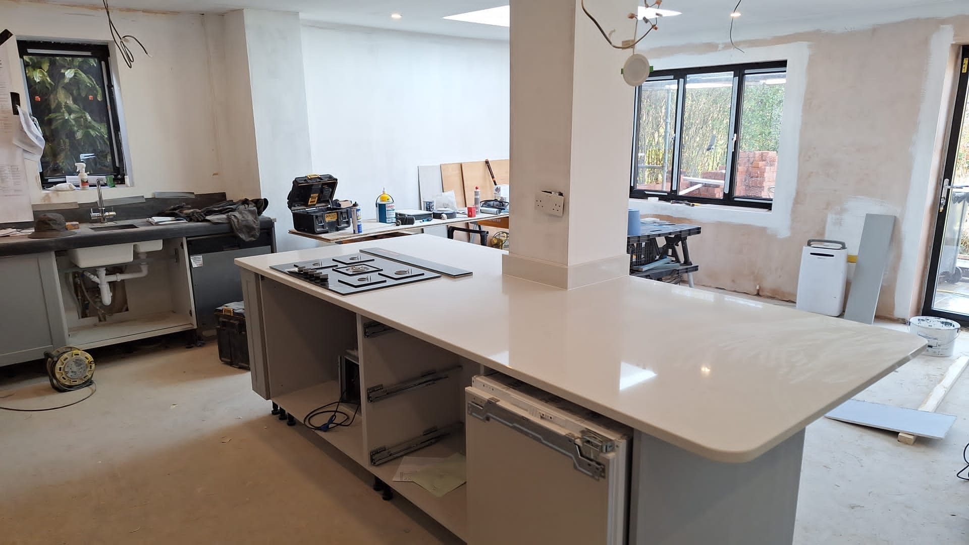 Quartz-topped kitchen island installed during a house refurbishment