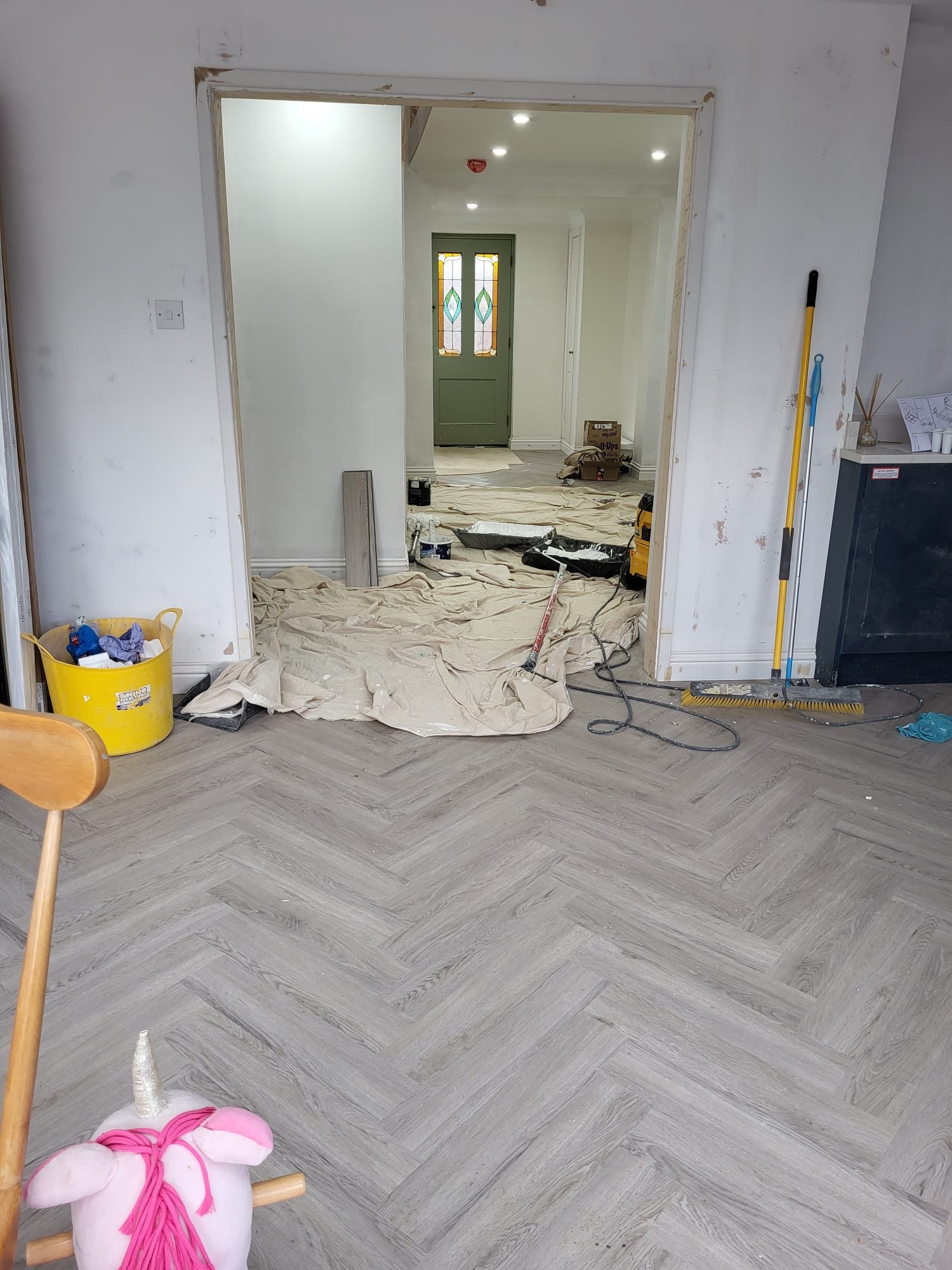Herringbone flooring laid through a hallway during a house refurbishment