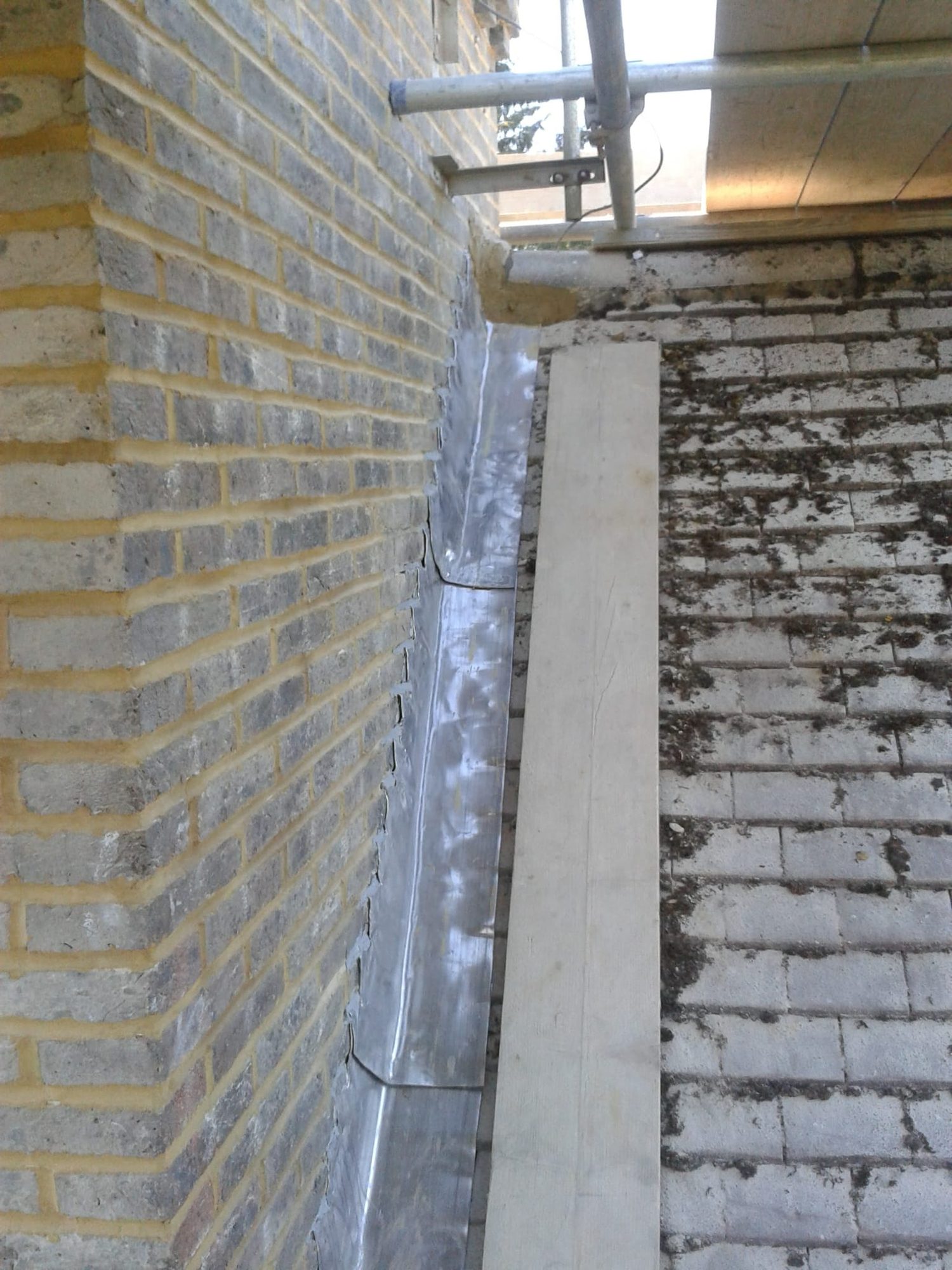Lead flashing and blockwork at a new structural wall junction